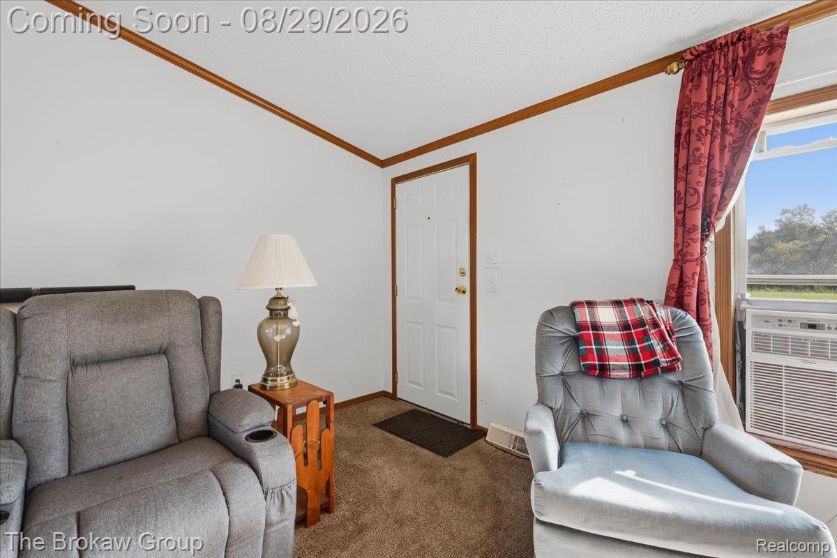 5189 North Webster Road Flushing, MI 48433 - Photo 9 of 46 White painted walls, wood trim accents, and a window with natural light