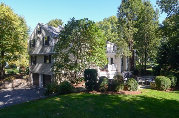 154 Hampshire Road Wellesley, MA 02481 - Photo 28 of 30 a front view of a house with a garden and yard