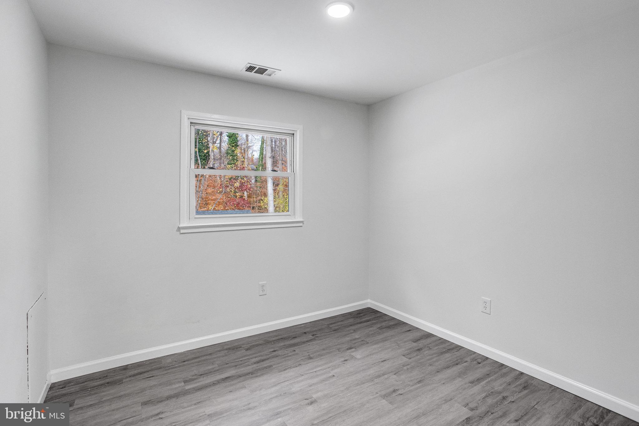 3412 North Beaumont Road Woodbridge, VA 22193 - Photo 13 of 34 wooden floor in an empty room with a window