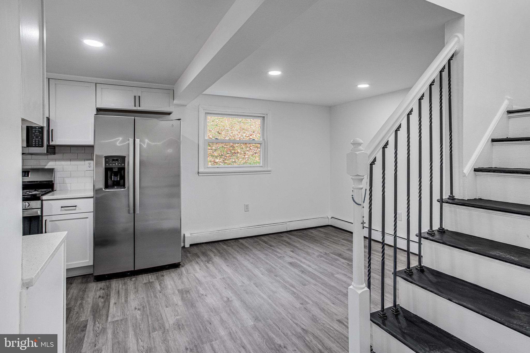 3412 North Beaumont Road Woodbridge, VA 22193 - Photo 17 of 34 a view of kitchen with wooden floor electronic appliances and stairs