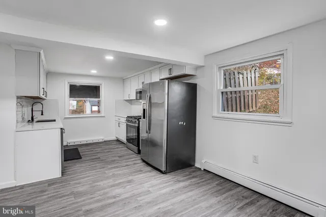a kitchen with stainless steel appliances a refrigerator and a stove top oven