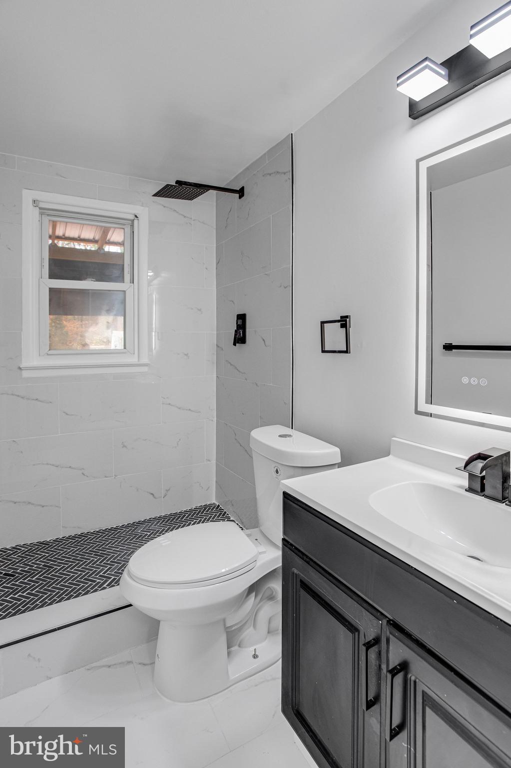 3412 North Beaumont Road Woodbridge, VA 22193 - Photo 24 of 34 a bathroom with a sink toilet vanity and shower