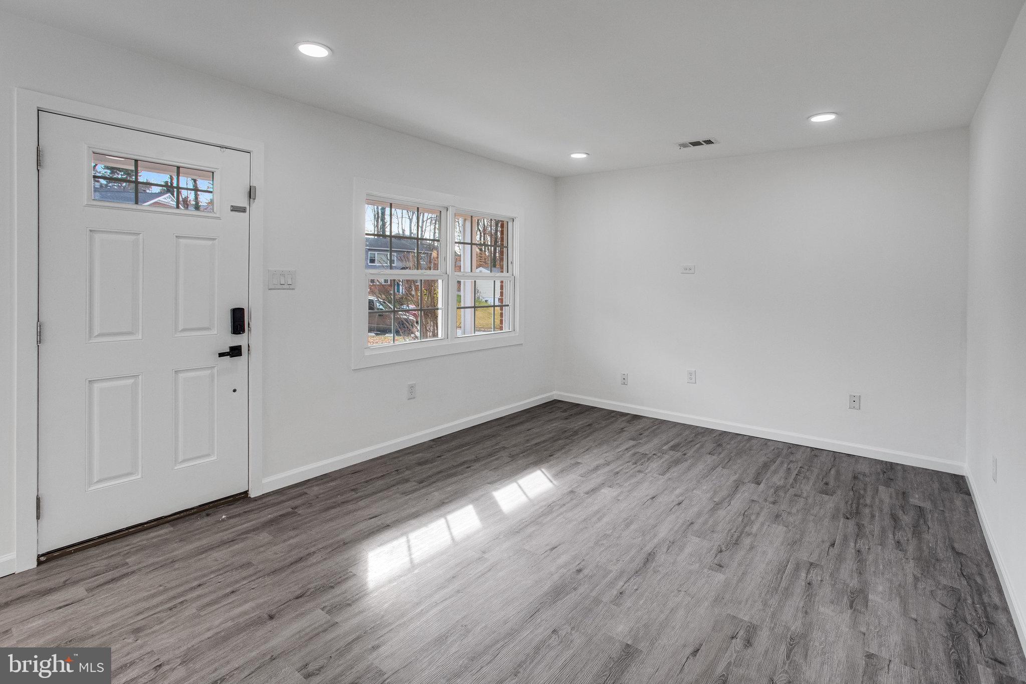 3412 North Beaumont Road Woodbridge, VA 22193 - Photo 4 of 34 a view of an empty room with wooden floor and a window