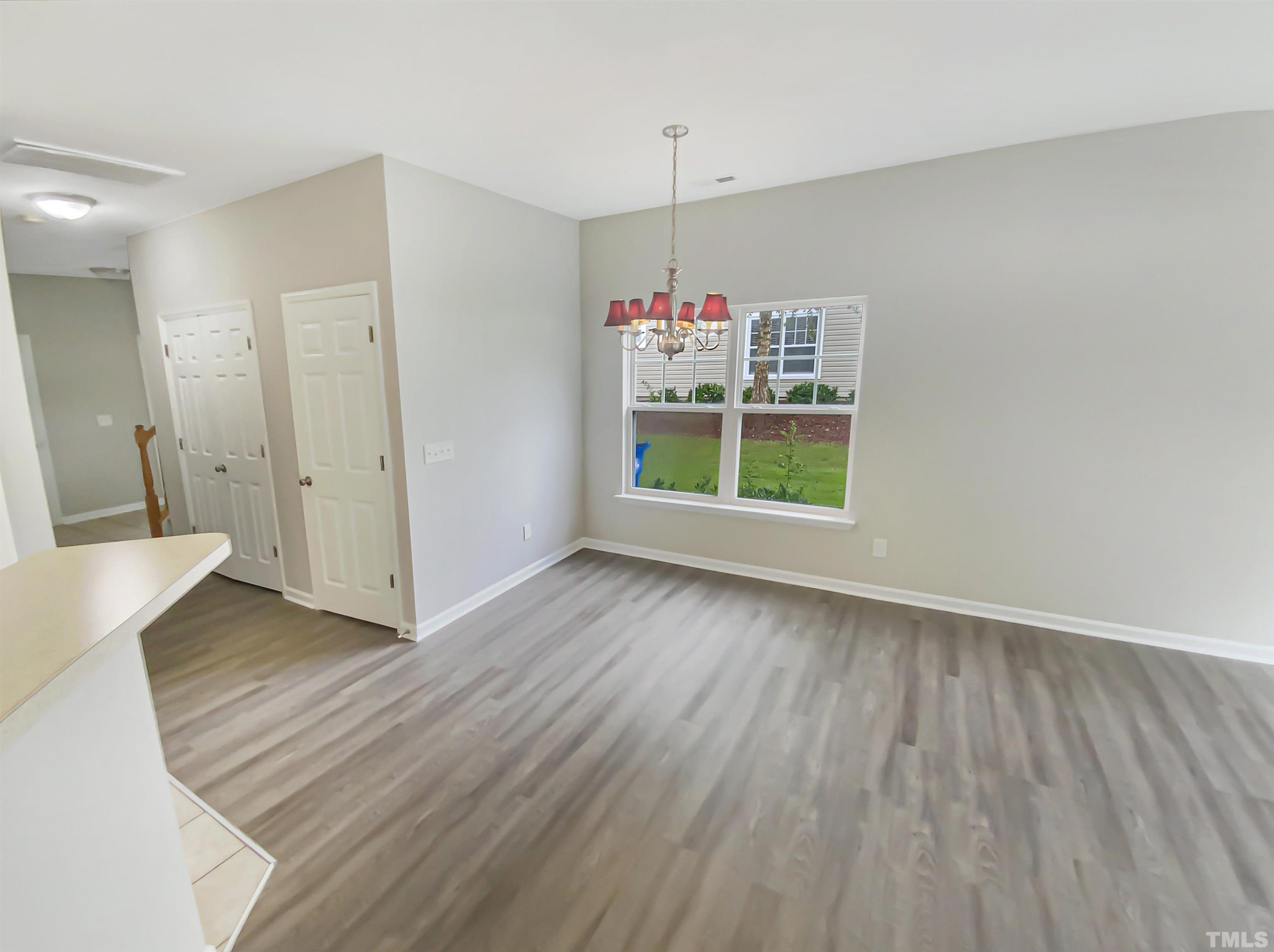5105 Sandy Banks Road Raleigh, NC 27616 - Photo 13 of 15 a view of an empty room with wooden floor and a window