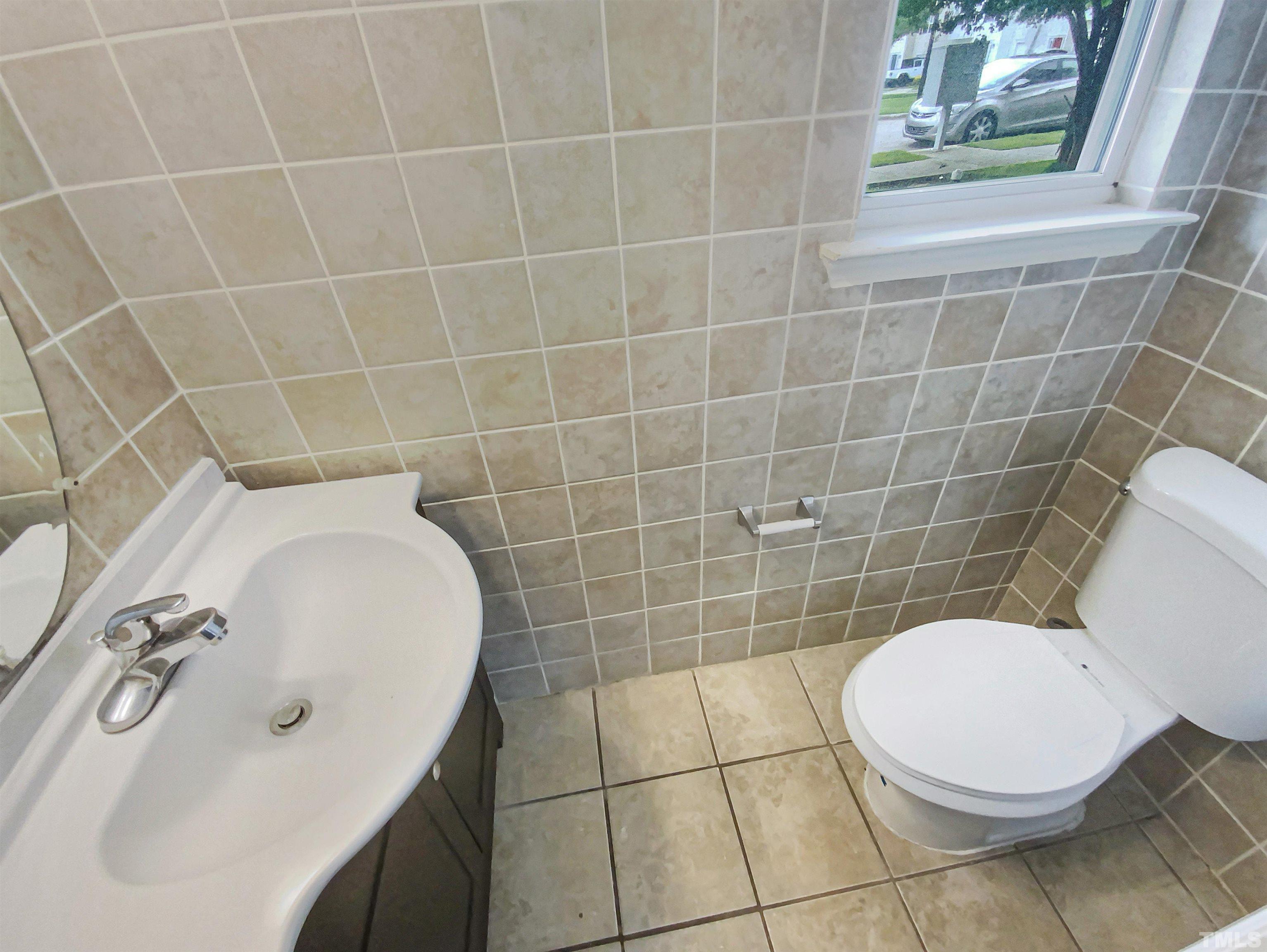 5105 Sandy Banks Road Raleigh, NC 27616 - Photo 14 of 15 a bathroom with a sink a toilet and a mirror