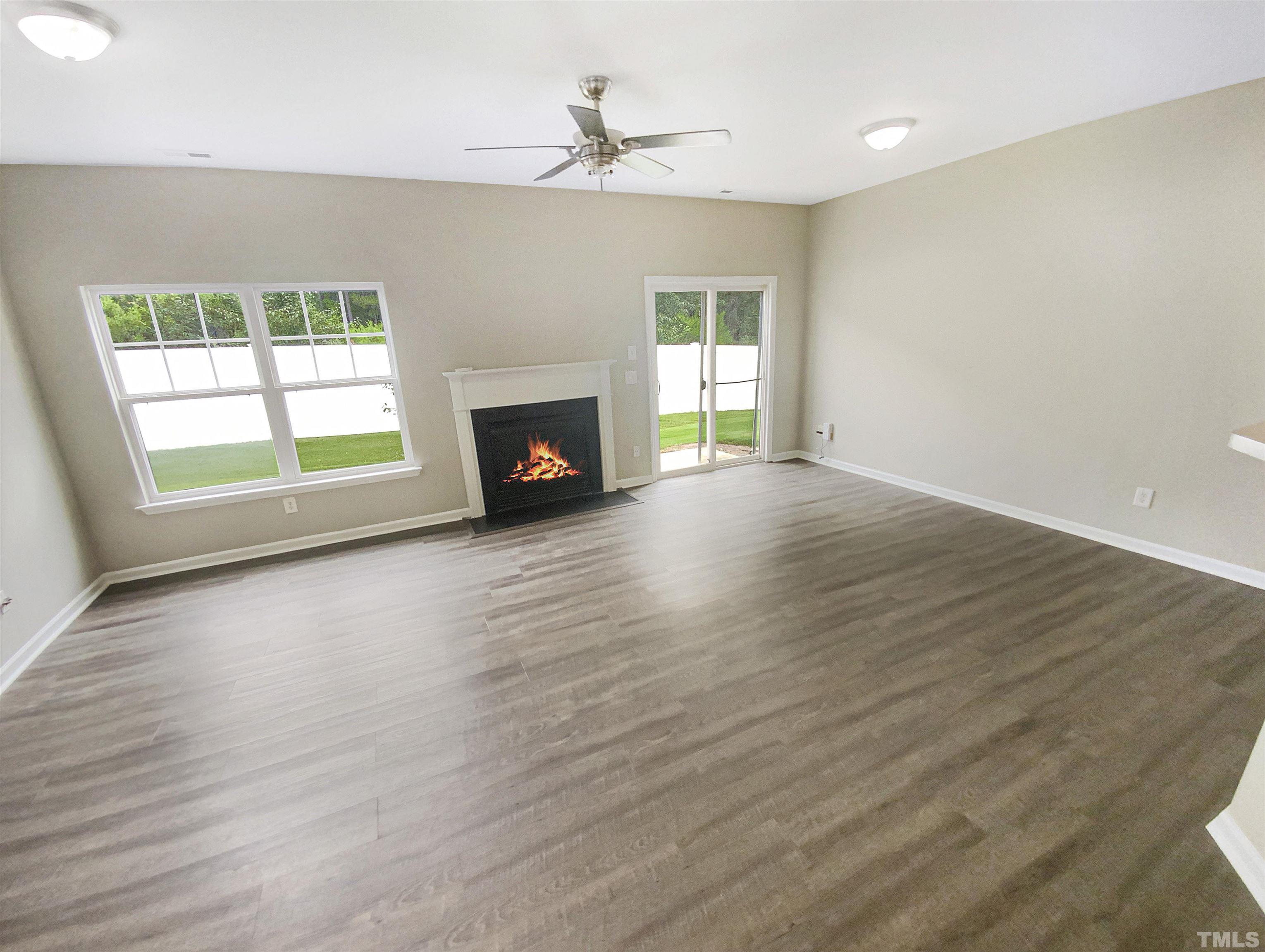 5105 Sandy Banks Road Raleigh, NC 27616 - Photo 3 of 15 an empty room with windows fireplace and a sink