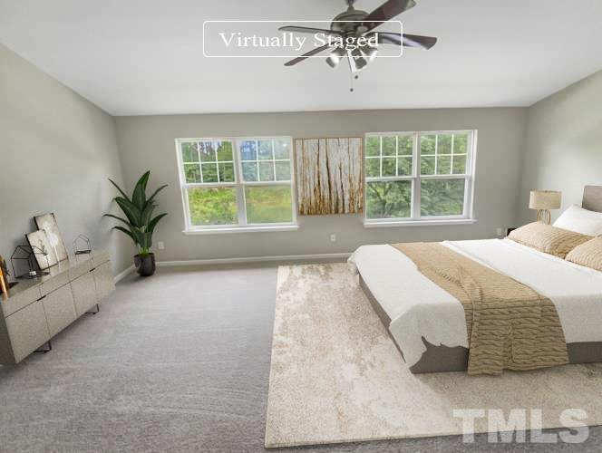5105 Sandy Banks Road Raleigh, NC 27616 - Photo 4 of 15 a spacious bedroom with a large bed and a window