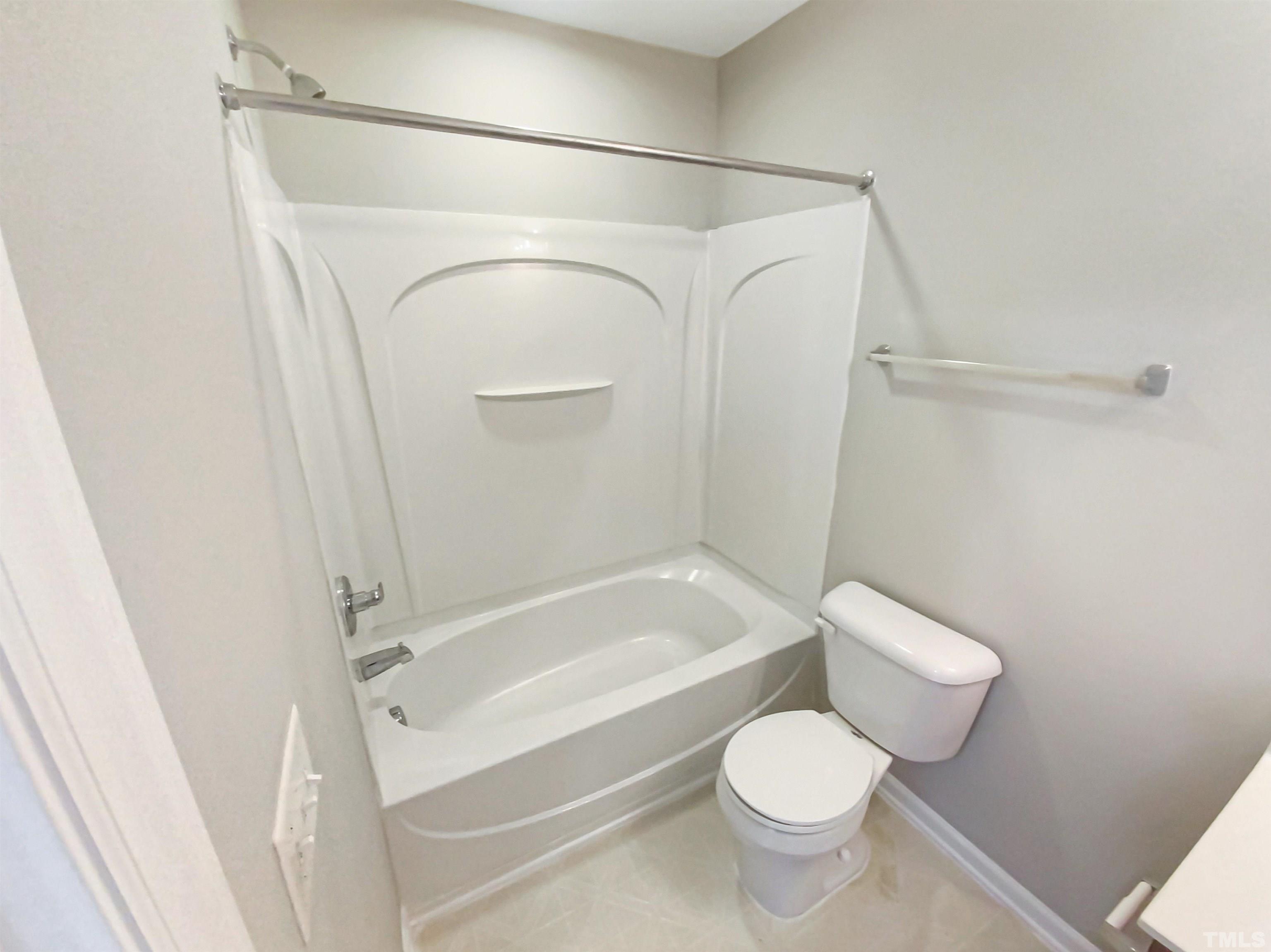 5105 Sandy Banks Road Raleigh, NC 27616 - Photo 10 of 15 a white toilet sitting next to a bath tub