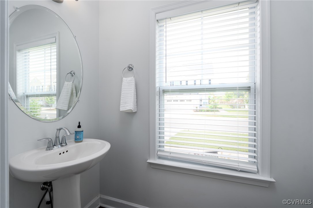 4816 Breeching Dee Lane Henrico, VA 23294 - Photo 12 of 25 a bathroom with a sink a mirror and a window