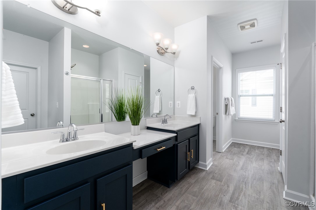 4816 Breeching Dee Lane Henrico, VA 23294 - Photo 15 of 25 a bathroom with a double vanity sink a mirror and a bathtub