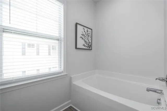 a white bath tub sitting next to a window