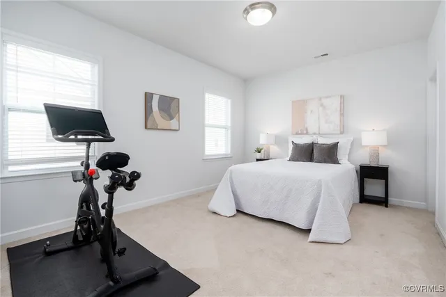 a bedroom with a bed window and a desk