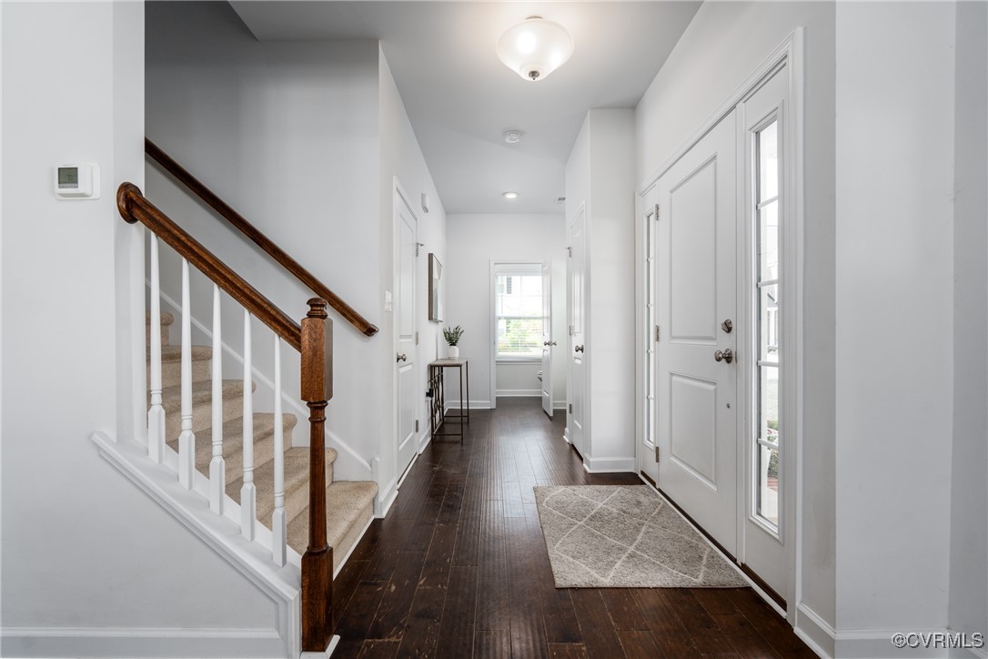 4816 Breeching Dee Lane Henrico, VA 23294 - Photo 4 of 25 a view of a hallway with wooden floor and staircase