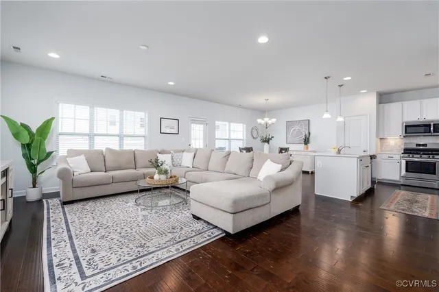 a living room with furniture and wooden floor