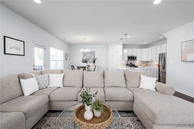 a living room with furniture and kitchen view