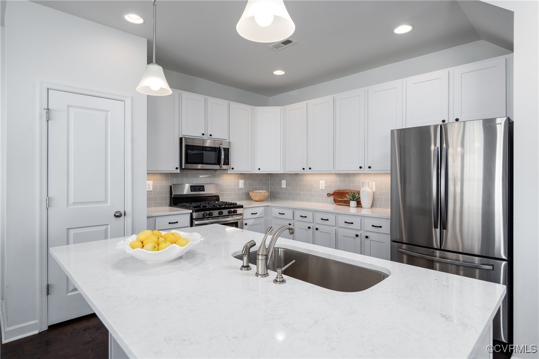 4816 Breeching Dee Lane Henrico, VA 23294 - Photo 9 of 25 a kitchen with a refrigerator a stove a microwave and island with wooden floor