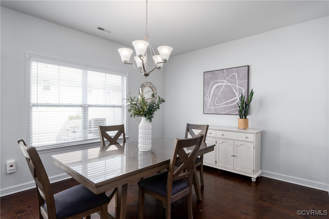 4816 Breeching Dee Lane Henrico, VA 23294 - Photo 10 of 25 a view of a dining room with furniture a chandelier and wooden floor