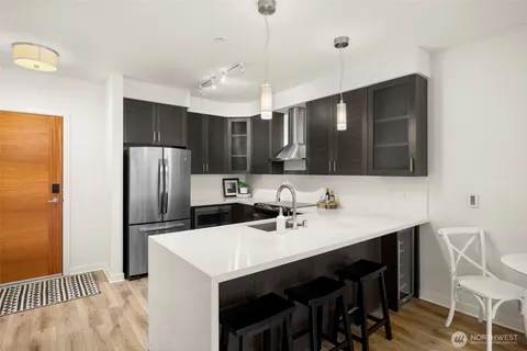 a kitchen with stainless steel appliances a sink stove and refrigerator