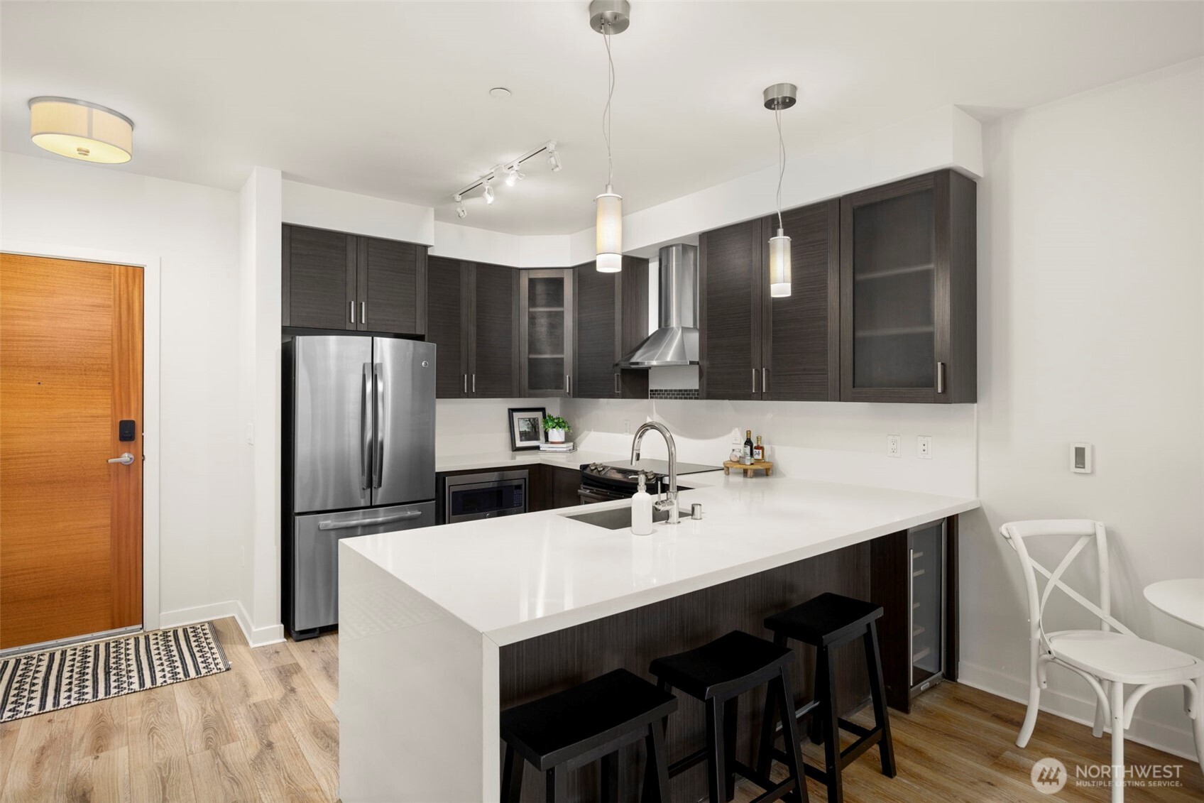 1760 Northwest 56th Street, Unit 309 Seattle, WA 98107 - Photo 11 of 30 a kitchen with stainless steel appliances a sink stove and refrigerator