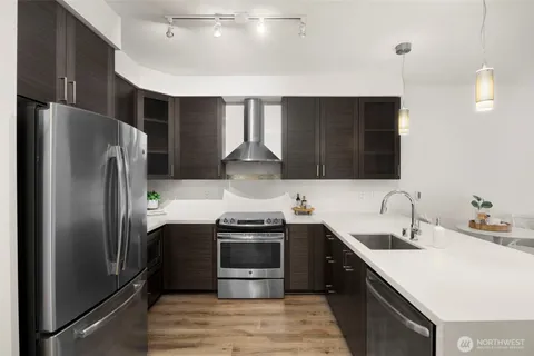 a kitchen with stainless steel appliances a sink stove and refrigerator