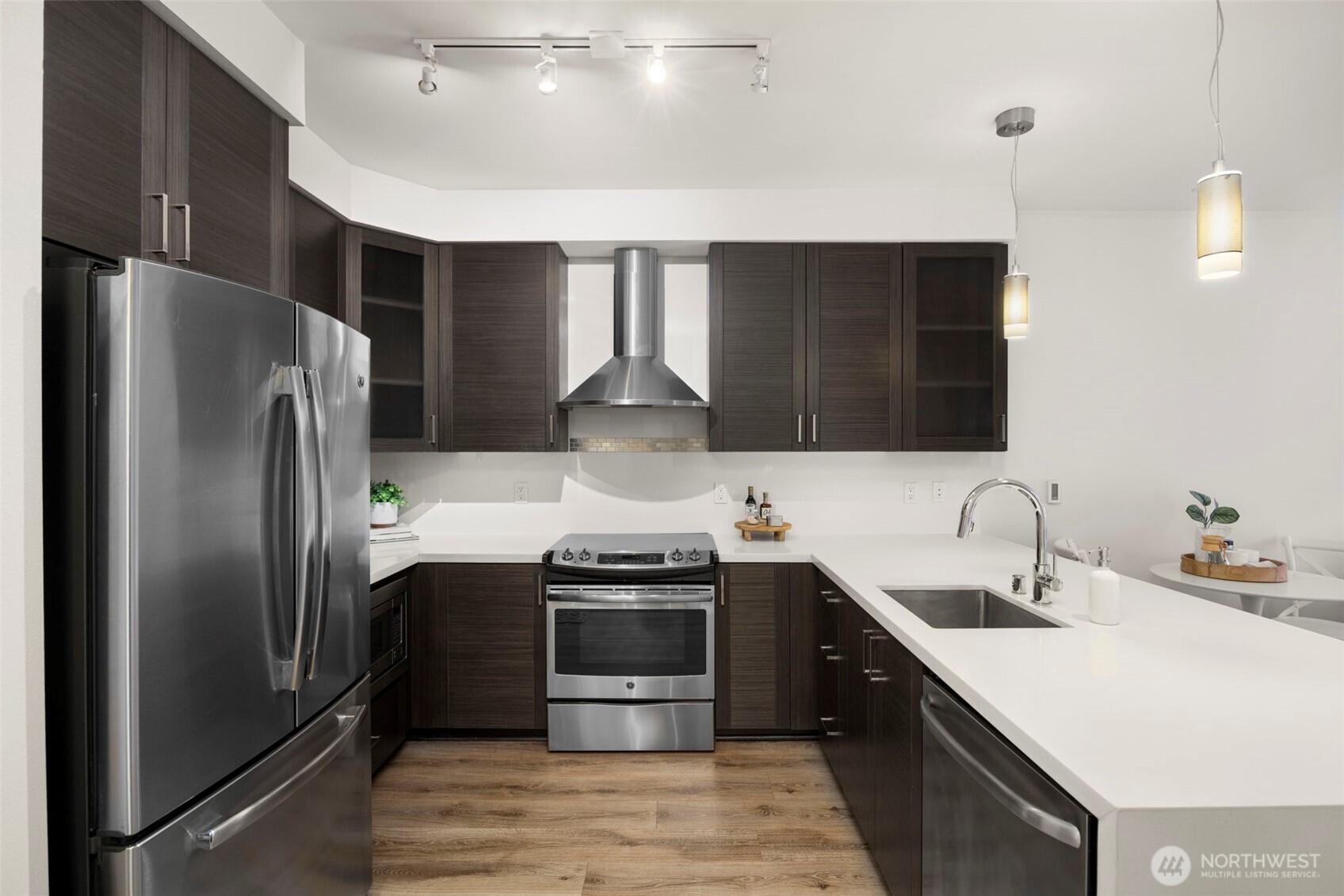 1760 Northwest 56th Street, Unit 309 Seattle, WA 98107 - Photo 12 of 30 a kitchen with stainless steel appliances a sink stove and refrigerator