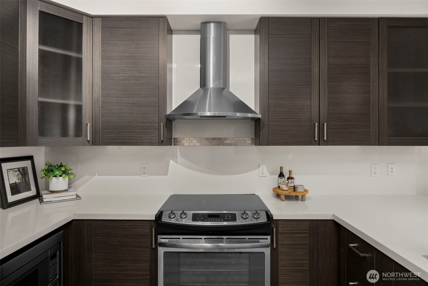 1760 Northwest 56th Street, Unit 309 Seattle, WA 98107 - Photo 13 of 30 a kitchen with a sink and cabinets