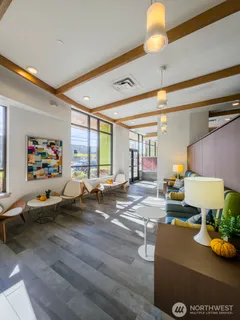 a living room with furniture and a lamp