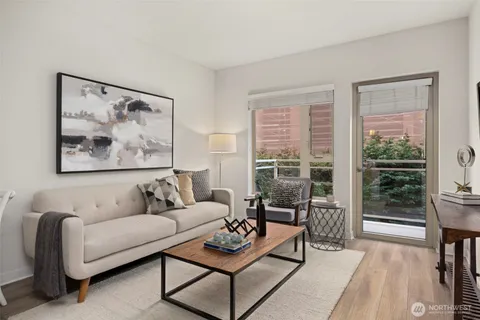 a living room with furniture and a large window with outer view