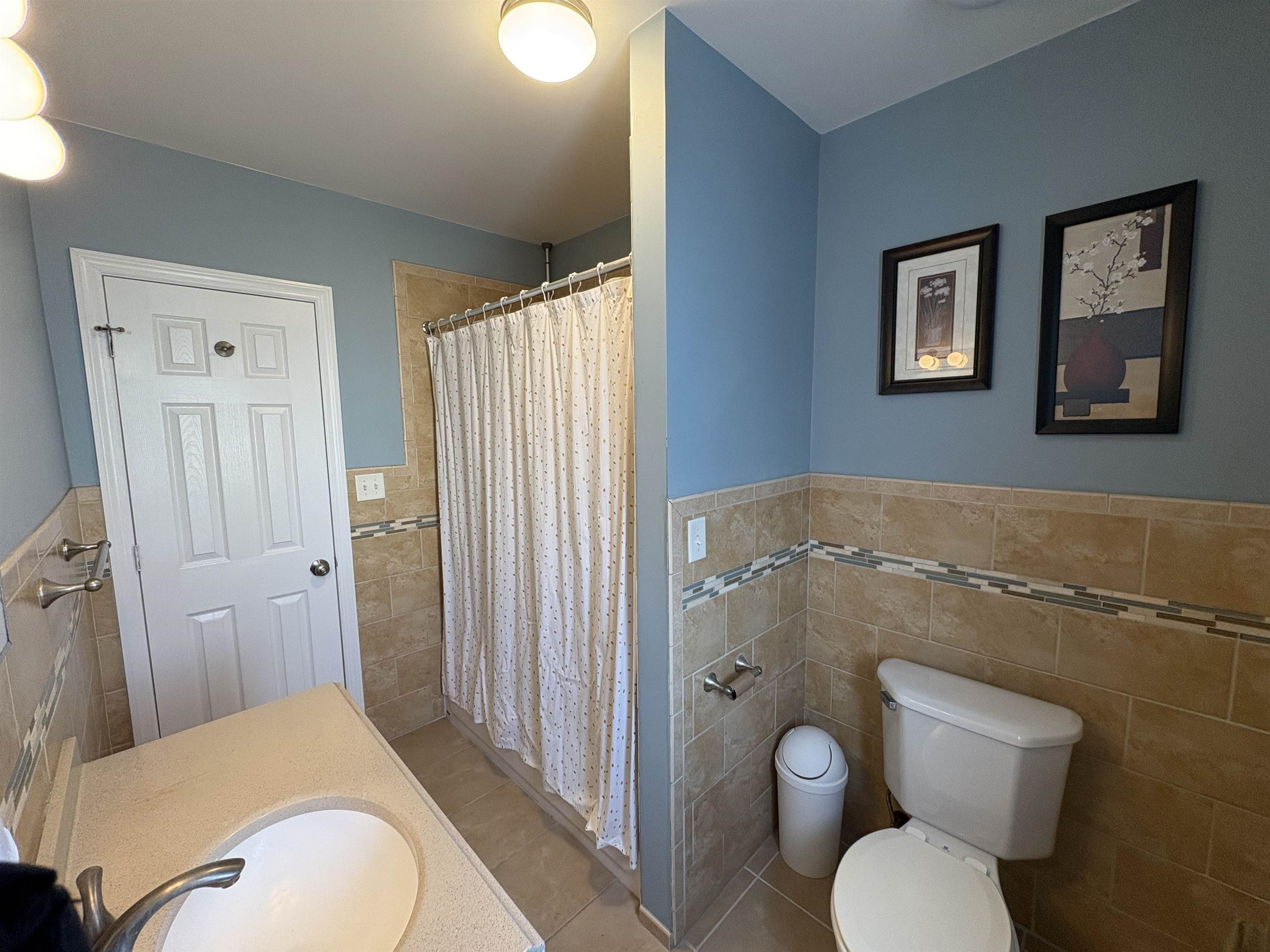 814 28th Street, Unit 2 Union City, NJ 07087 - Photo 12 of 12 a bathroom with a granite countertop toilet sink and mirror