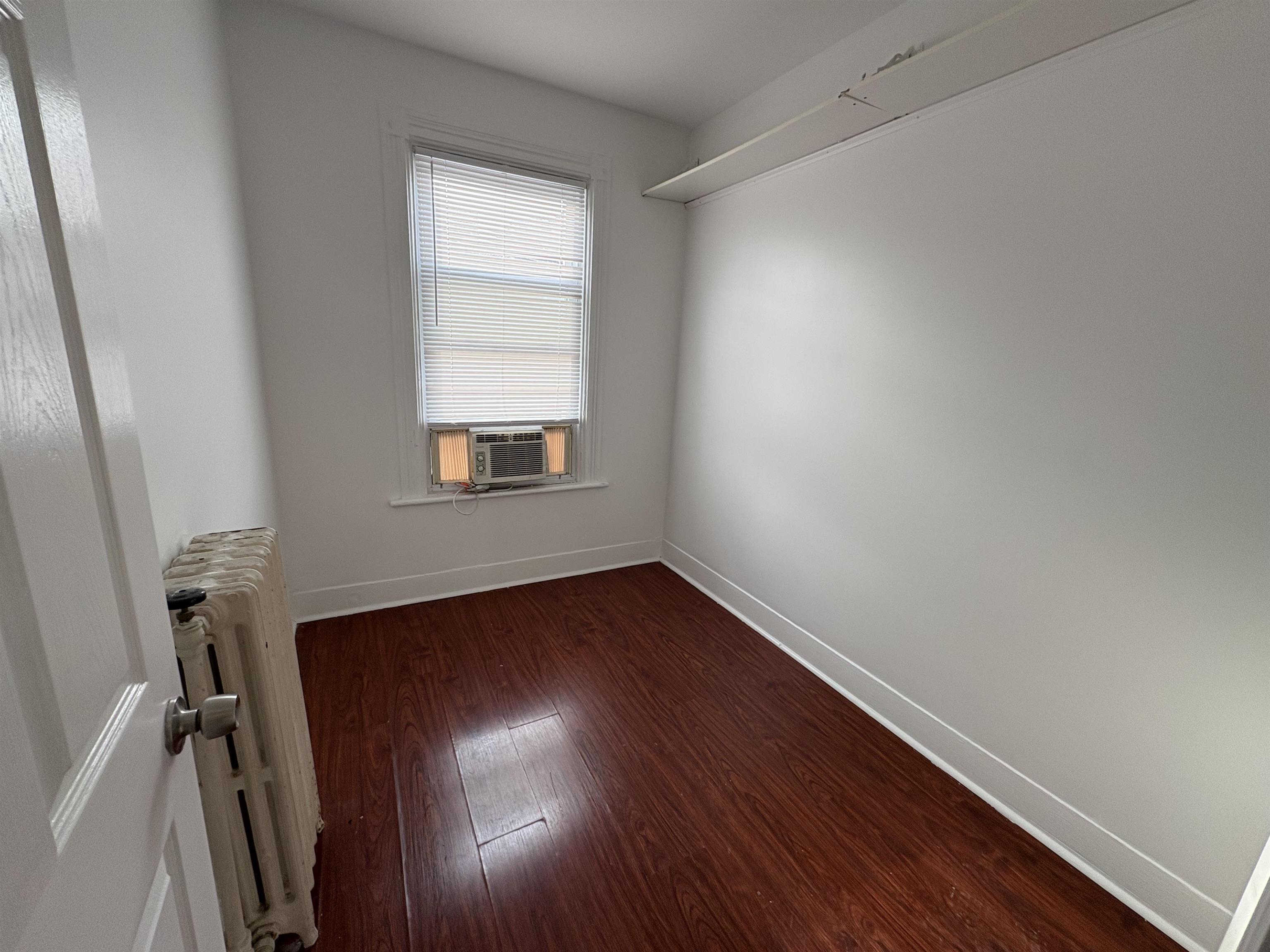 814 28th Street, Unit 2 Union City, NJ 07087 - Photo 7 of 12 an empty room with wooden floor and windows