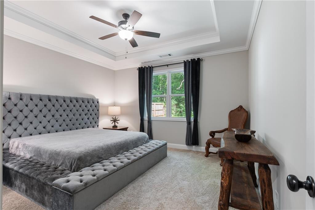 245 Hospital Road Commerce, GA 30529 - Photo 11 of 33 a bedroom with a bed and a chandelier