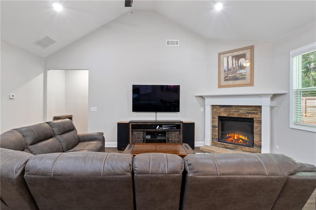 245 Hospital Road Commerce, GA 30529 - Photo 15 of 33 a living room with furniture a flat screen tv and a fireplace