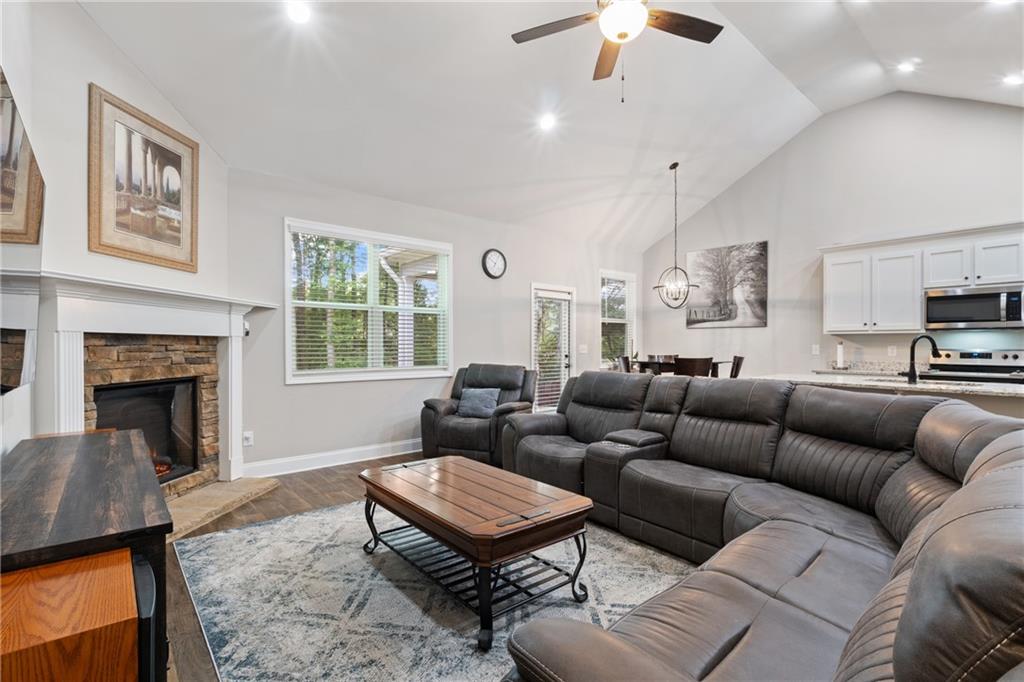 245 Hospital Road Commerce, GA 30529 - Photo 2 of 33 a living room with furniture a fireplace and a chandelier
