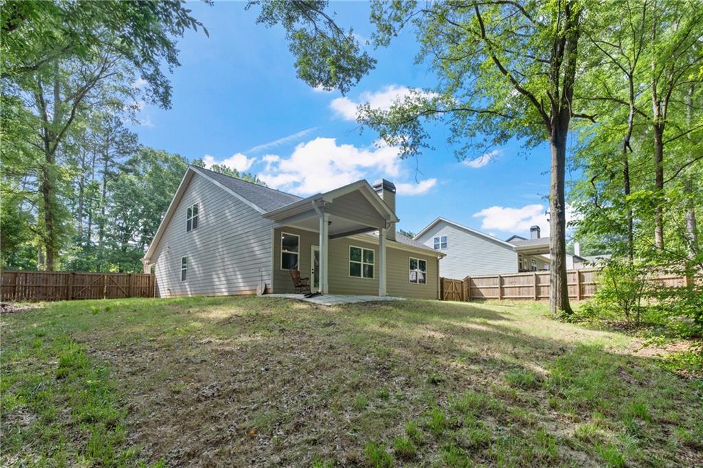 245 Hospital Road Commerce, GA 30529 - Photo 22 of 33 a big house with a big yard and large trees