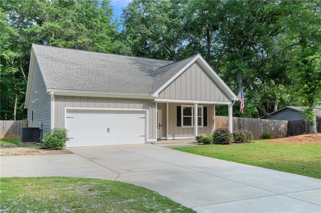 245 Hospital Road Commerce, GA 30529 - Photo 25 of 33 a front view of a house with a yard and trees