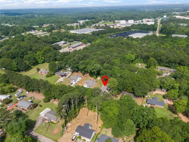 a front view of multi story residential apartment building with yard and green space
