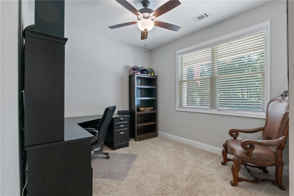 245 Hospital Road Commerce, GA 30529 - Photo 8 of 33 a view of a workspace with furniture and a window