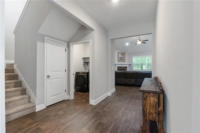 a view of a hallway view with wooden floor and staircase