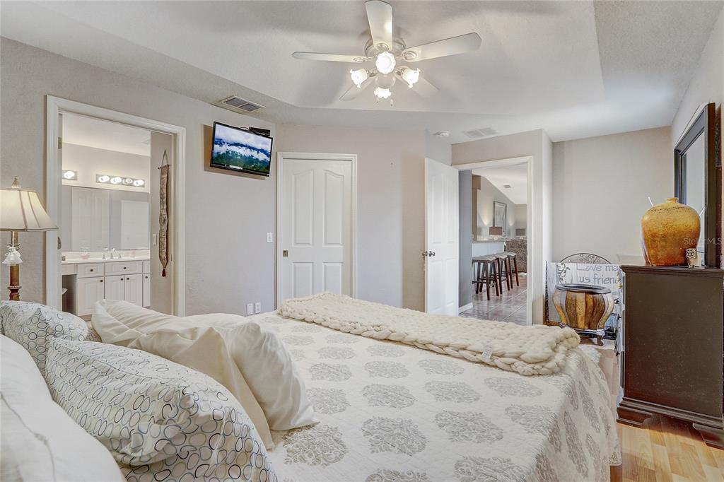 10031 Southwest 62nd Circle Ocala, FL 34476 - Photo 13 of 25 a bedroom with a bed chandelier and a window