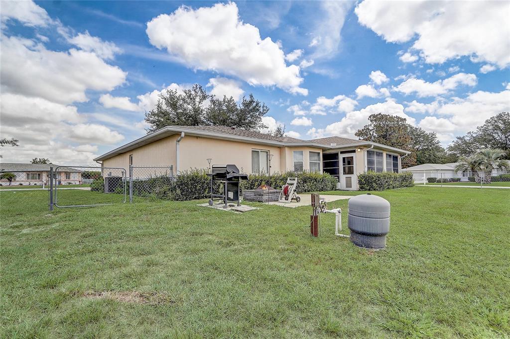 10031 Southwest 62nd Circle Ocala, FL 34476 - Photo 19 of 25 a backyard of a house with table and chairs