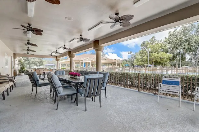 a view of a porch with furniture and a yard