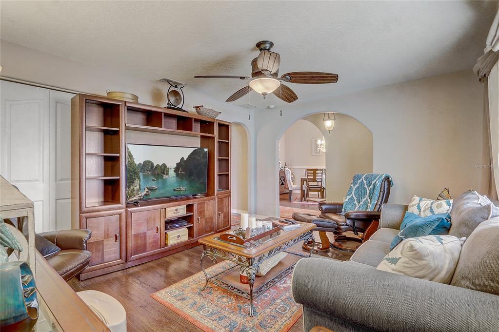 10031 Southwest 62nd Circle Ocala, FL 34476 - Photo 5 of 25 a living room with furniture ceiling fan and a large window