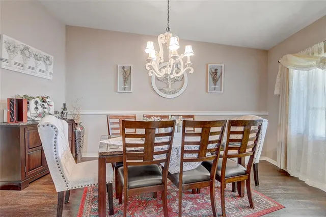 a dining room with furniture a rug and wooden floor