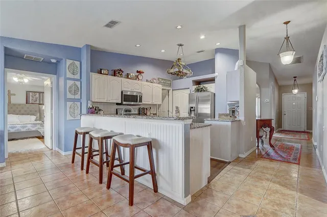 a kitchen with stainless steel appliances kitchen island granite countertop a sink and cabinets