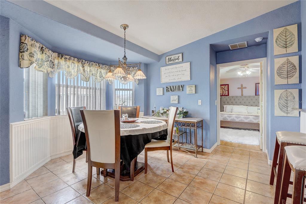 10031 Southwest 62nd Circle Ocala, FL 34476 - Photo 10 of 25 a view of a dining room with furniture window and outside view