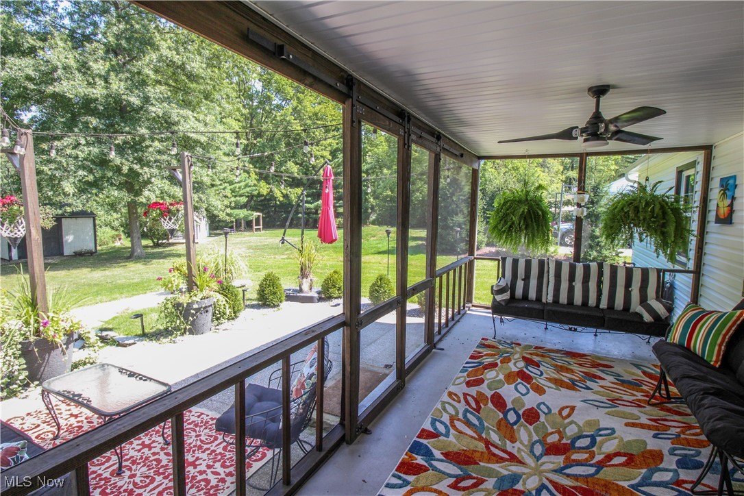 207 Harmon Road Aurora, OH 44202 - Photo 35 of 40 Screened in porch with ceiling fan and access to patio and yard.