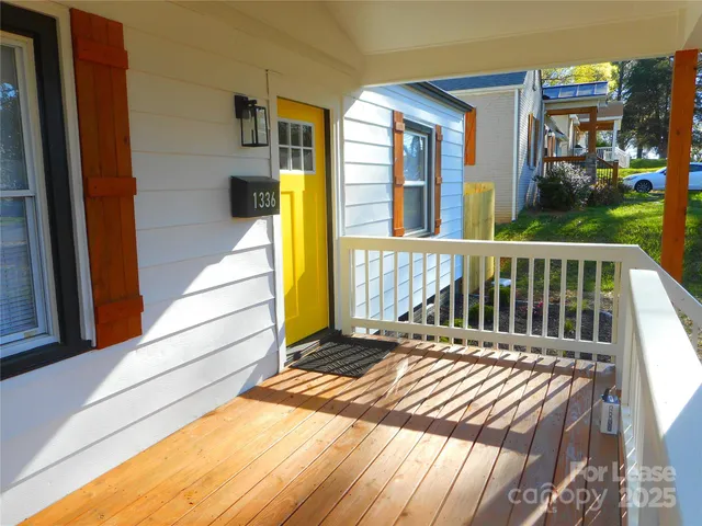 a view of balcony with wooden floor and outdoor seating