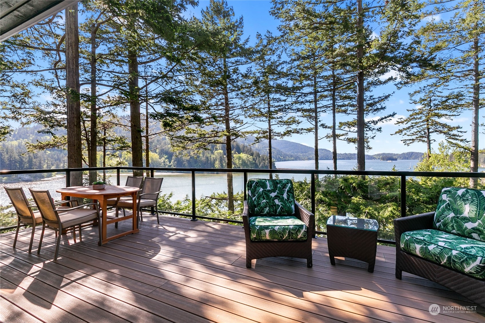 324 Sea Pines Road Bellingham, WA 98229 - Photo 3 of 40 a roof deck with table and chairs potted plants and a large tree