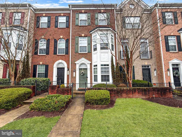 a front view of a residential apartment building with a yard