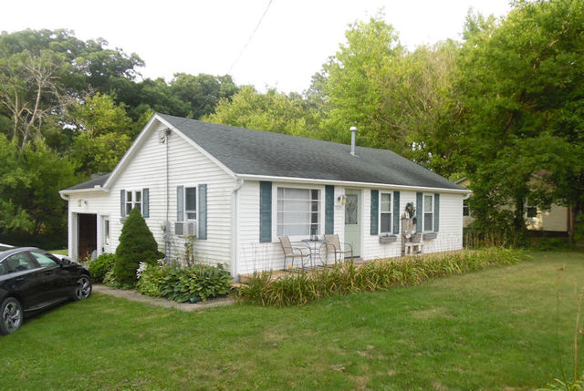 a front view of house with yard and green space